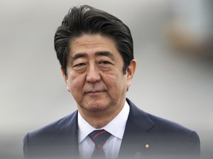 Japanese Prime Minster Shinzo Abe arrives at Joint Base Pearl Harbor Hickam, Monday, Dec. 26, 2016, in Honolulu.  Abe will visit Pearl Harbor with U.S. President Barack Obama Tuesday, becoming the first leader of Japan to visit Pearl Harbor, the site of the surprise attack that propelled the United States into World War II.  This year marks the 75th anniversary of the Japanese attack.  (AP Photo/Marco Garcia)