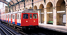 A train arriving at Notting Hill Gate at the London Underground, London, England. Subway train platform, London Tube, Metro, London Subway, public transportation, railway, railroad.