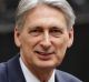 Britain's Chancellor of the Exchequer Philip Hammond poses for the media with his traditional red dispatch box outside ...