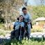 Image of young man in wheelchair with friend