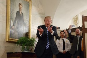 President Donald Trump greets visitors touring the White House in Washington, Tuesday, March 7, 2017.