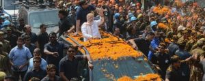 Indian Prime Minister Narendra Modi waves to supporters as he campaigns for his party in Varanasi, Uttar Pradesh.