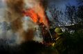 A NSW Fire Brigade member fights a fire in the Lake Macquarie area this summer. The levy for emergency services will ...