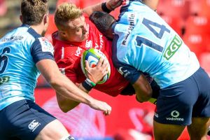 JOHANNESBURG, SOUTH AFRICA - MARCH 04: Ruan Ackermann of the Lions tackled by Jack Dempsey of the Waratahs and Reece ...