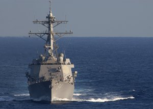 The guided-missile destroyer USS Nitze (DDG 94) trails behind the aircraft carrier USS Theodore Roosevelt (CVN 71