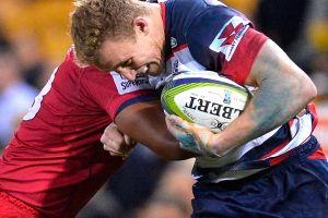 BRISBANE, AUSTRALIA - JULY 15: Reece Hodge of the Melbourne Rebels attempts to break away from the defence during the ...