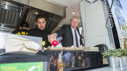 Professor Schmidt assisting with the service of a chanchito at the Union Court PopUp village announcement. Photo by Stuart Hay, ANU.