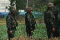 Troops stand in front of an unfinished medical centre at the Wat Dhammakaya temple compound in Pathum Thani province, ...