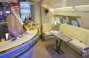 An Emirates Airlines cabin crew attendant stands in the new bar area for the Airbus A380 aircraft during the unveiling ...