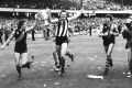 Richmond players Geoff Raines, Michael Roach (wearing a Collingwood guernsey) and Mick Malthouse after their grand final ...