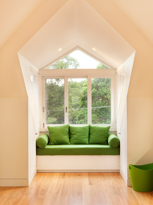 Photo of a transitional family room in Sydney with beige walls and medium hardwood floors.