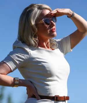 Looking smart: Chloe Shorten listens as her husband, Opposition Leader Bill Shorten, addresses the media in Logan, ...