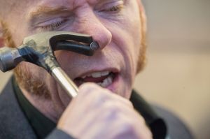 Albert Cadabra uses a hammer to remove a nail from his nose during the 10th annual World Sword Swallower's Day at the ...