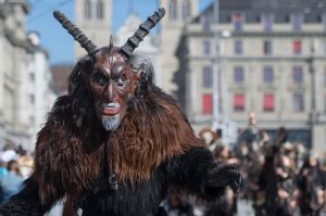 Masked revellers parade through the streets, during the carnival in Lucerne, Switzerland,