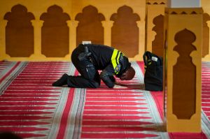 A Dutch police officer prays at the Al Kabir mosque in Amsterdam, Netherlands, Sunday, March 5, 2017, where a meeting ...