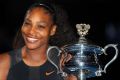 Serena Williams poses with the trophy after winning the Australian Open.