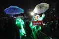 People wearing electronic lights attached to their clothing perform during a rally calling for impeached President Park ...