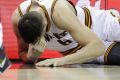 Damage done: Andrew Bogut grimaces after the collision.