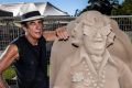 Sand sculptor Dennis Massoud with his tribute to Dame Edna Everage.