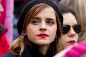 Actress Emma Watson sit with the crowd during the Women's March on Washington, Saturday, Jan. 21, 2017 in Washington. ...