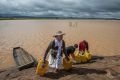 Residents cross flooded land in Madagascar's capital Antananarivo, on Friday.