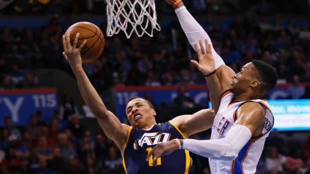 Utah Jazz guard Dante Exum (left) shoots in front of Oklahoma City Thunder guard Russell Westbrook.