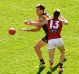 The Tigers' Brett Deledio handballs while being tackled by Bomber Orazio Fantasia in the round 17 match.