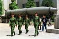 Chinese soldiers march past a missile on display at Beijing's Military Museum.