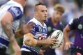 Running man: Josh Reynolds takes on the Storm defence on Friday night.