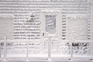 Frozen sea spray from a winter storm coats a house in Scituate, Mass., Wednesday, Jan. 28, 2015.