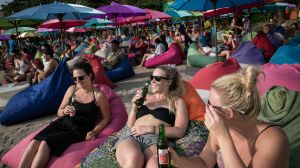 Tourists drink beer in Seminyak, Bali. Aussies will soon be outnumbered on "the island of the Gods". 