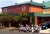 Police motor bikes and a hearse sit outside St Patrick's College, Shorncliffe