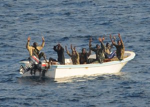 File - GULF OF ADEN (Feb. 11, 2009) –Suspected pirates keep their hands in the air as directed by the guided-missile cruiser USS Vella Gulf (CG 72) as the visit, board, search and seizure (VBSS) team prepares to apprehend them.