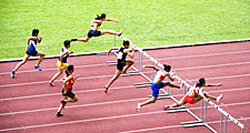 Men jumping hurdles (track sport; athletics; athlete)