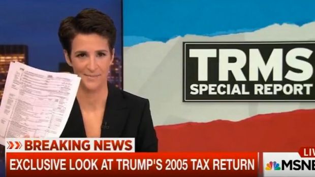 MSNBC host Rachel Maddow holds up documents purported to be Donald Trump's tax return.