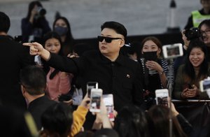 An unidentified man dressed as the North Korean leader Kim Jong Un as he tries to walk on the red carpet of the 2016 Mnet Asian Music Awards (MAMA) in Hong Kong, Friday, Dec. 2, 2016.