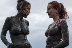 Women wade in a pool of mud during the traditional "Bloco da Lama" or "Mud Street" carnival party, in Paraty, Brazil, ...