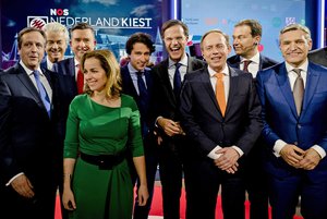 Democrats 66 party leader Alexander Pechtold, right-wing populist leader Geert Wilders, Socialist Party leader Emile Roemer, Party for the Animals' Marianne Thieme, Green Left party leader Jesse Klaver, Dutch Prime Minister Mark Rutte, Gert-Jan Segers of the Christian Union, Labour Party leader Lodewijk Asscher, and Christan Democrats party leader Sybrand Buma, from left, pose for a picture after the closing debate at parliament in The Hague, Netherlands