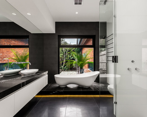 Large contemporary master bathroom in Melbourne with a vessel sink, flat-panel cabinets, white cabinets, a freestanding tub and a corner shower.