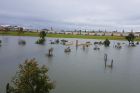 A park submerged aside from a lone bench in Jindalee.