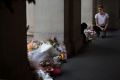 Time to move on: Barista Jordan Briggs, whose booth in the former GPO verandah overlooks the floral shrine to the Bourke ...