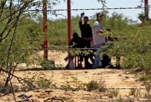 Three strands of barbed wire, shown Wednesday, May 5, 2004, at the San Miguel gate crossing point in San Miguel, Ariz., are all that divides Mexico and the United States.