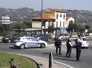 Police officers take position after an attack in a high school student in Grasse, southern France, Thursday, March 16, 2017.