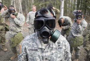 File - Army Staff Sgt. Henry Cancinos conducts chemical, biological, radiological and nuclear defense training at Joint Base Elmendorf-Richardson, Alaska, April 13, 2016.