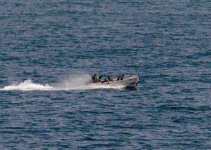 Somali pirates holding the MV Faina conduct a resupply Friday, Oct. 3, 2008 while under observation by a U.S. Navy ship.