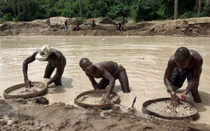 FILE- In this Wednesday May. 24, 2000 file photo, diamond prospectors sift through the earth in the Corbert mine in Waiima, Sierra Leone, 40 kilometers (25 miles) east of Bo in central Sierra Leone