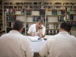 Offenders read and write papers inside the Southwestern Baptist Theological Seminary library located in the Darrington Unit of the Texas Department of Criminal Justice men's prison in Rosharon, Texas