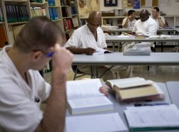 Offenders read books and write papers at a library in the Texas Department of Criminal Justice men's prison in Rosharon, Texas