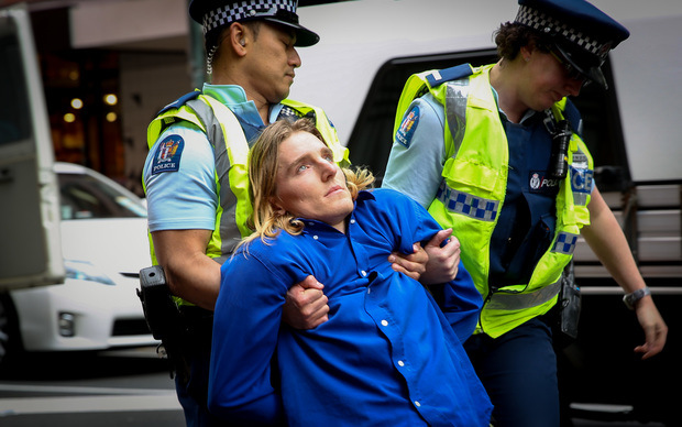 TPPA action group protester getting dragged off from the protest.