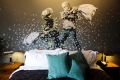 Banksy's wall painting showing an Israeli border policeman and a Palestinian in a pillow fight in one of the suites of ...